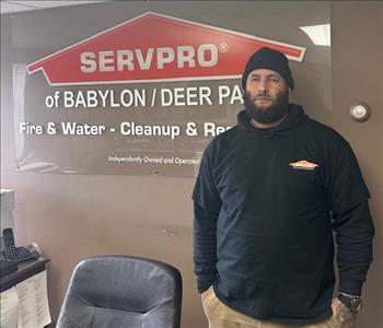 SERVPRO employee in black shirt posing for crew photo.